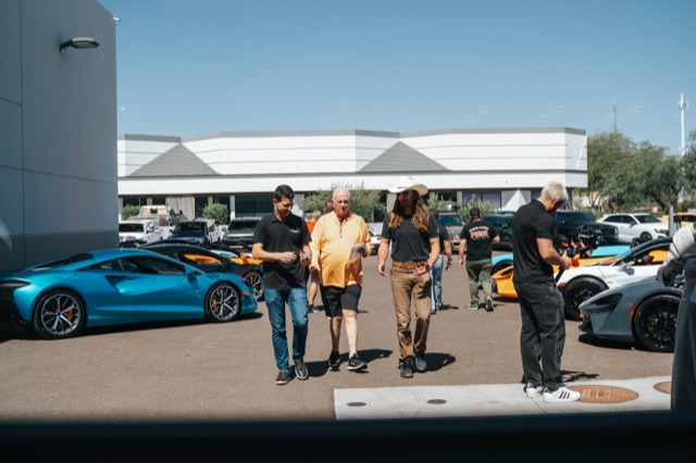Guests mingling among supercars