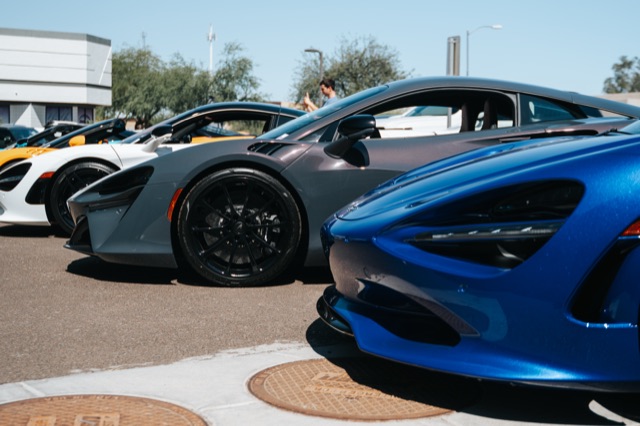 Row of McLaren supercars staged at a night event